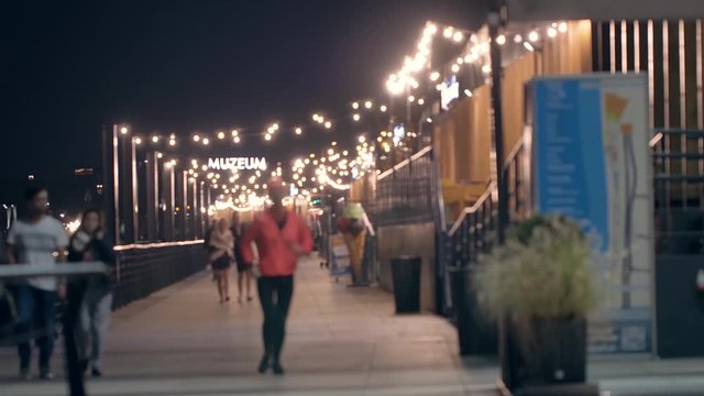 Unrecognizable people on the promenade. Evening n Warsaw.