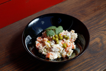 Olivier vegetable salad of home cooking, closeup photo.