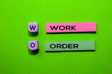 WO - Work Order acronym write on sticky notes isolated on Green background.