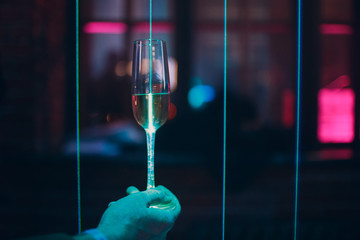 Glasses with a drink in the laser light of a nightclub