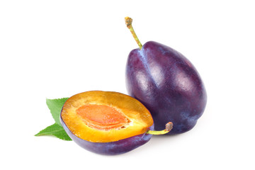 fresh plum fruit with green leaf and cut plum slices isolated on white background