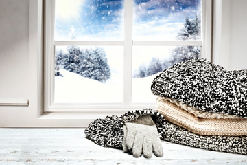 Snowy winter outside the window background with space on wooden board top for products and decorations. Christmas decorations.