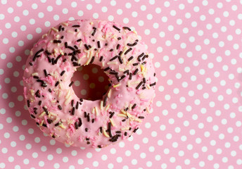 Colored donut on a pink background