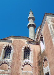 Fototapeta na wymiar the suleiman mosque in rhodes old town with tall minaret against a blue sunlit sky