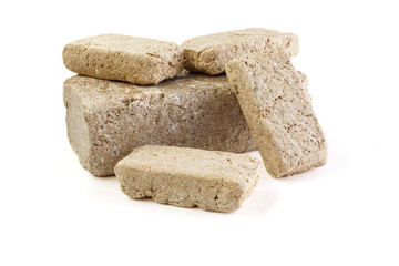 Halva sunflower cut into pieces Isolated on white background . Sweet halva dessert slices.