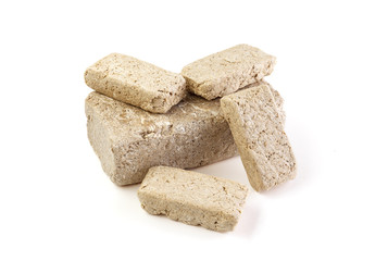 Halva sunflower cut into pieces Isolated on white background . Sweet halva dessert slices. Full depth of field.
