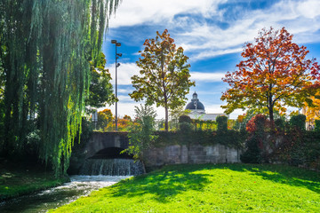 View on creek and waterfall in English Garden of Munich in Bavaria in the autumn