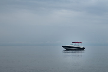 Motor boat, yacht on the surface of calm sea