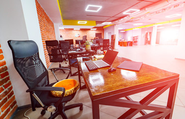 Modern office room, Design of a working place. Brick wall background. Wooden style table.