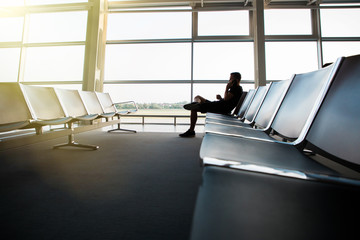 Young handsome man using smart phone at airport terminal