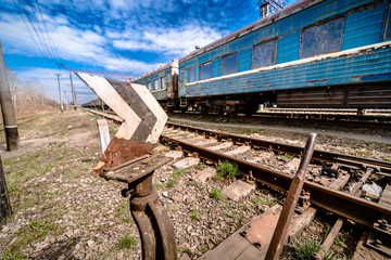 old rusty weathered peeled paint of an old wagon. Blue abandoned railway carriage. Old railwaystation.