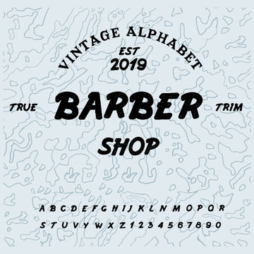 Barbershop typeface / Retro alphabet in western style / Slab Serif type letters on a grunge background / Handmade Vintage Font for labels and posters. Letters and numbers. Vector Illustration.