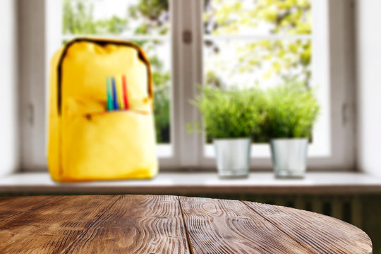 Table top with window and schoolbag background. Sunny day outside the window. School time.
