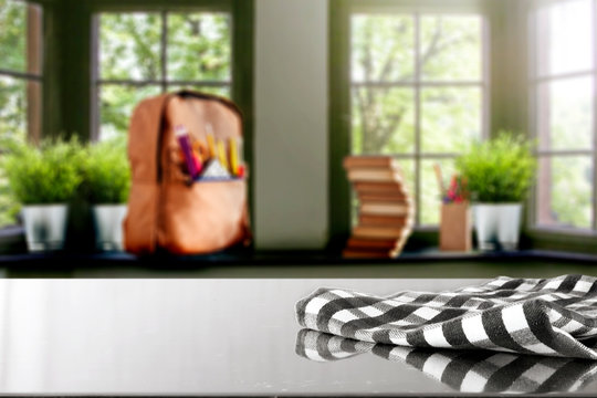 Table top with window and schoolbag background. Sunny day outside the window. School time.