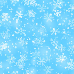 Christmas seamless pattern of snowflakes of different shapes, sizes and transparency in light blue colors