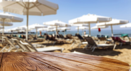 Table background with beautiful blue ocean and sandy beach. Summer sunny day. Empty space for your decoration and advertising product.