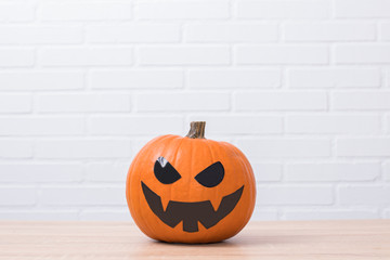 halloween pumpkin isolated on brick wall background