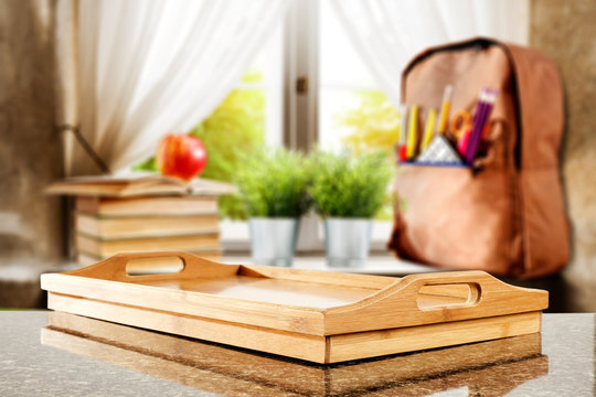 Table top with window and schoolbag background. Sunny day outside the window. School time.