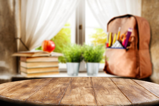 Table top with window and schoolbag background. Sunny day outside the window. School time.