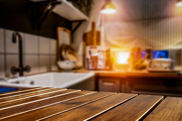 Fototapeta premium Wooden table background on a blurred kitchen goods and accessories view. Empty space for decoration and advertising products.