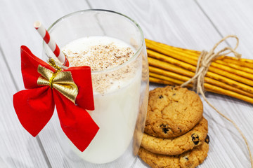 Composition with Christmas cookies and milk on white background