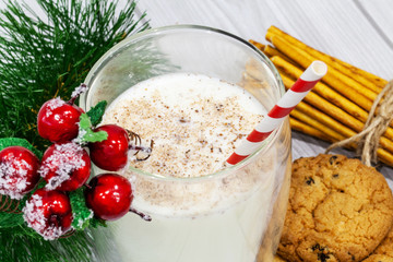 Composition with Christmas cookies and milk on white background
