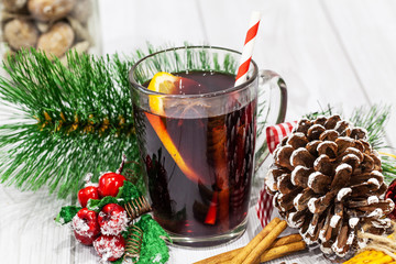 Hot mulled wine with spices on Christmas background