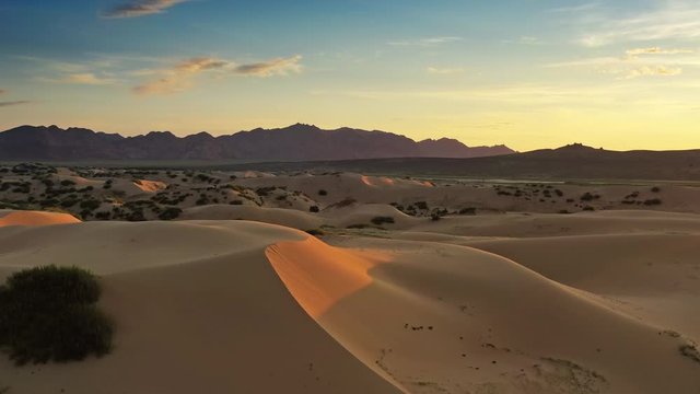 Aerial view of the sand dunes Elsen Tasarhai (Bayan Gobi) at sunrise in Mongolia, 4k