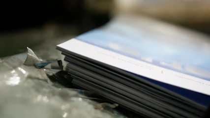 Old vintage printing press is working draws paper in printing factory. - Powered by Adobe