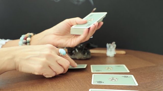 Miami, Florida. August 24, 2019. Tarot cards, illustrative editorial Rider Waite tarot cards. Female hands lays out tarot cards.