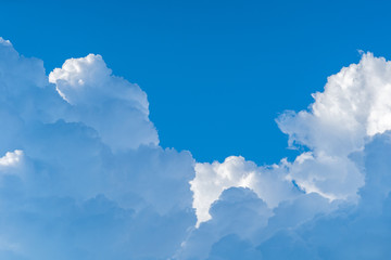 Blue sky white cumulus clouds before storm in summer cast shadow