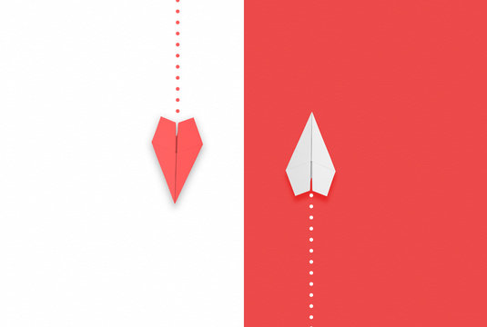 red and white paper airplane flying different directions.different thinking concept