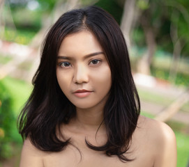 Close-up pictures of beautiful young Asian women, with perfect smooth tan skin. Concept of natural cosmetics and skincare.