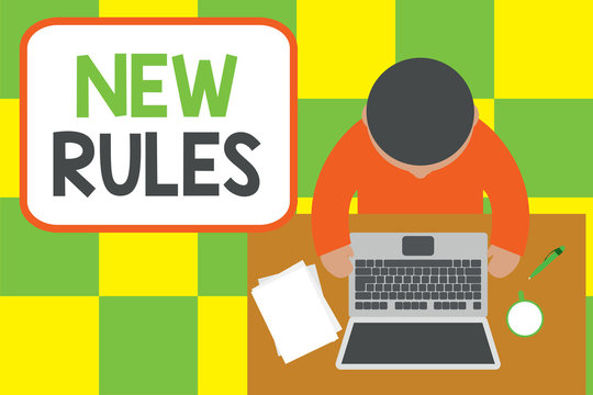 Conceptual hand writing showing New Rules. Concept meaning A state of changing an iplemented policy for better upgrade Upper view young man sitting table laptop coffee cup pen