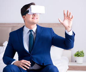 Businessman wearing a virtual reality headset in the bedroom
