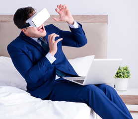 Businessman wearing a virtual reality headset in the bedroom