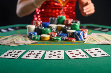 Girl plays cards in a casino, a lot of chips, cards, video. Success and win. Poker