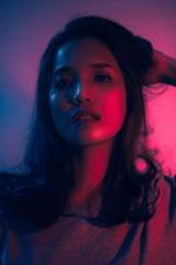 Beautiful woman face. Red and blue light color. Double light colors of potrait.