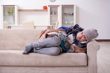 Fototapeta premium Young man suffering at home