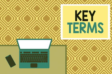 Conceptual hand writing showing Key Terms. Concept meaning Words that can help a demonstrating in searching information they need Office working place laptop lying wooden desk smartphone