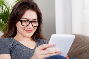 Fototapeta premium young woman using digital tablet at home