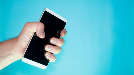 person squeezing cell phone in hand