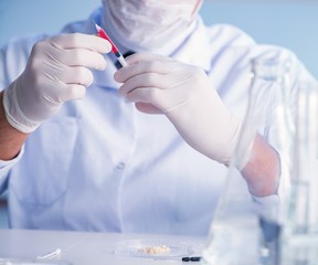 Female scientist researcher conducting an experiment in a labora