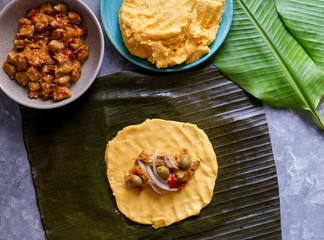 Venezuelan christmas food - hallaca - corn dough stuffed with a stew of pork and chicken and...