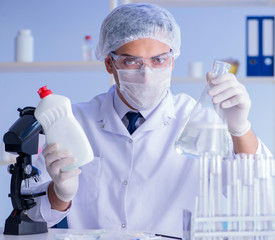 Man in the lab testing new cleaning solution detergent