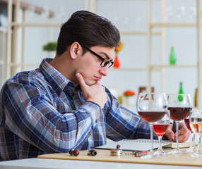 Professional sommelier tasting red wine