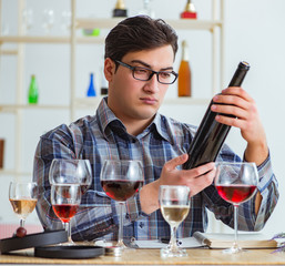 Professional sommelier tasting red wine