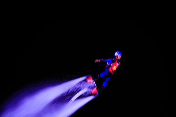 Water stunts performance at night in a park