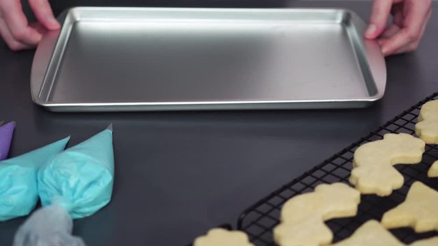 Decorating unicorn sugar cookies with multi-color royal icing.