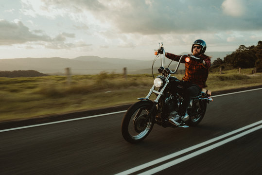 Man Riding His Motorcylce Through A Scenic Landscape